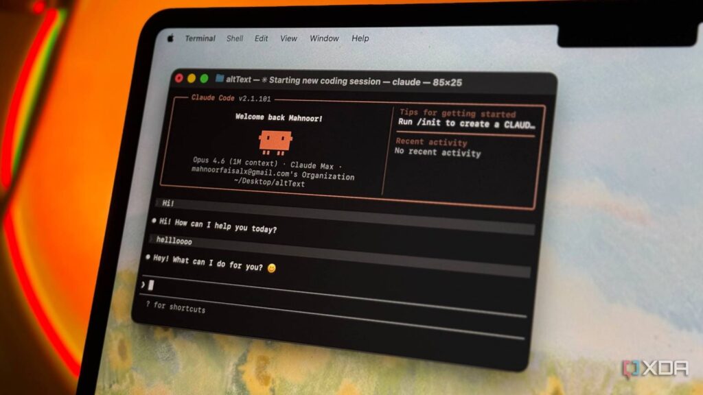 claude code displayed on terminal window on mac laptop with orange background.jpg