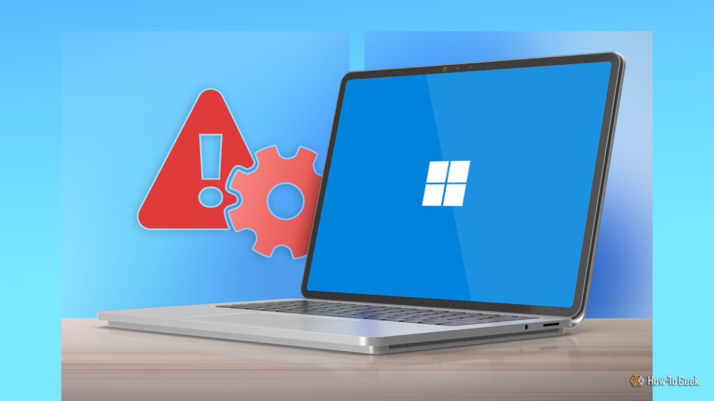 laptop displaying the windows 11 logo on its screen with a red warning icon and gear symbol beside i.png