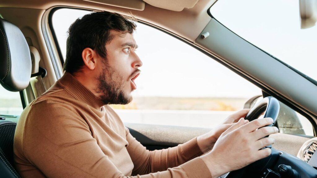 driver frustrated by giving voice commands.jpg