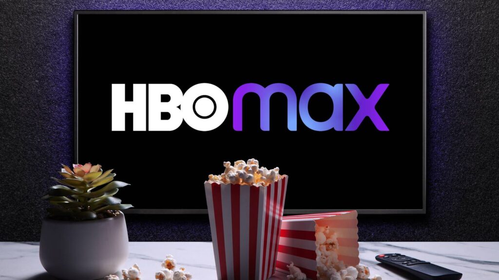 8 new presentations and flicks streaming on HBO Max in June hbo max logo on tv with popcorn boxes remote control and home plant on the table.jpg
