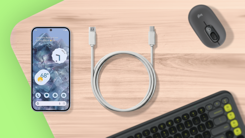 usb c to hdmi cable on a wooden desk with a smartphone keyboard and mouse.png