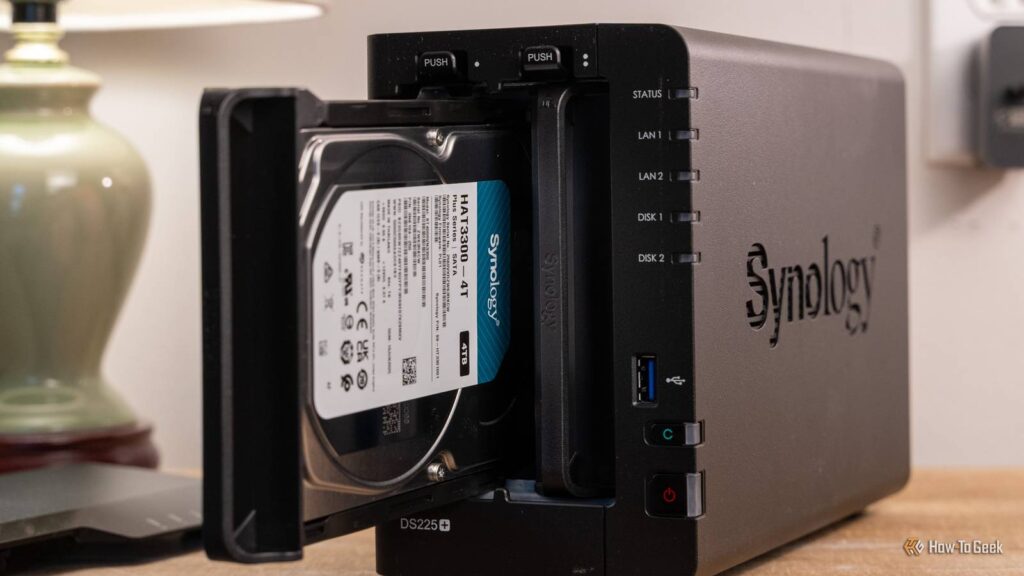 synology ds225 plus 2 bay nas with a synology hat3300 4t drive sliding into the front bay.jpg